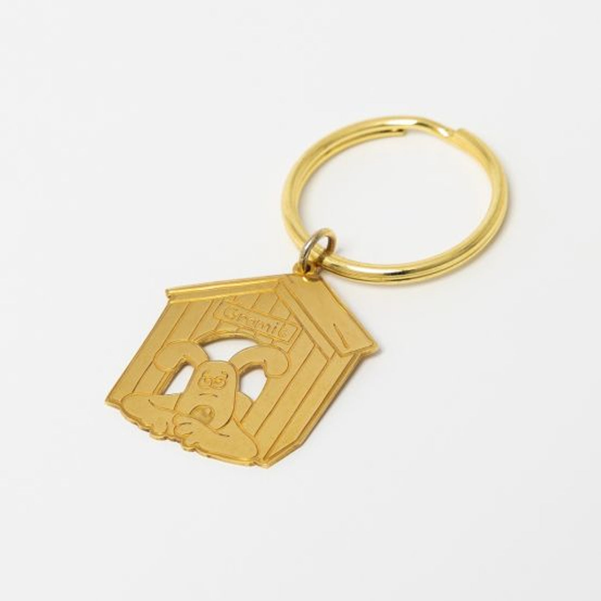 Key ring 327930 Brass Gromit in the kennel The Cartoon Museum