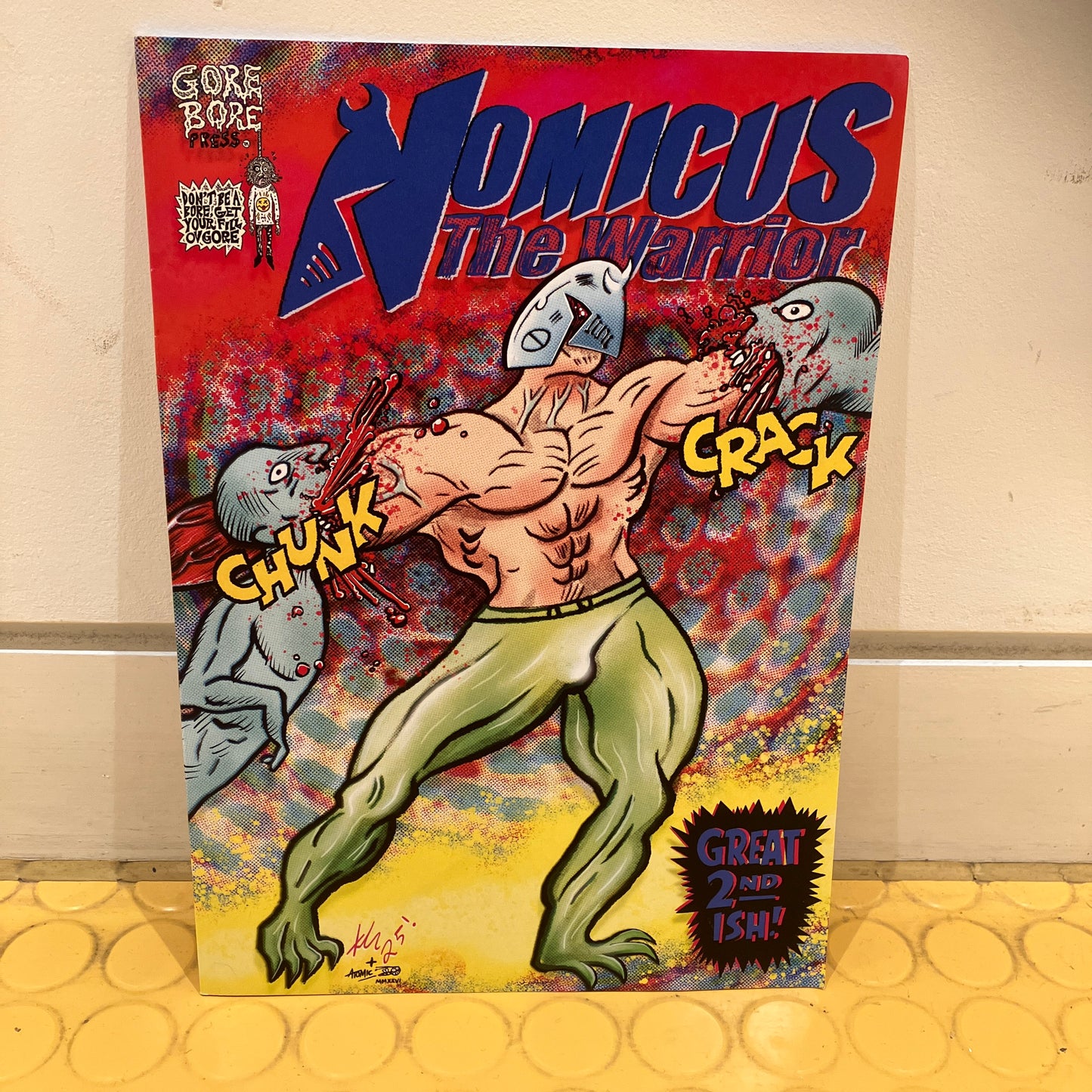 Comic book cover featuring a muscular character with a grey creature on a red background